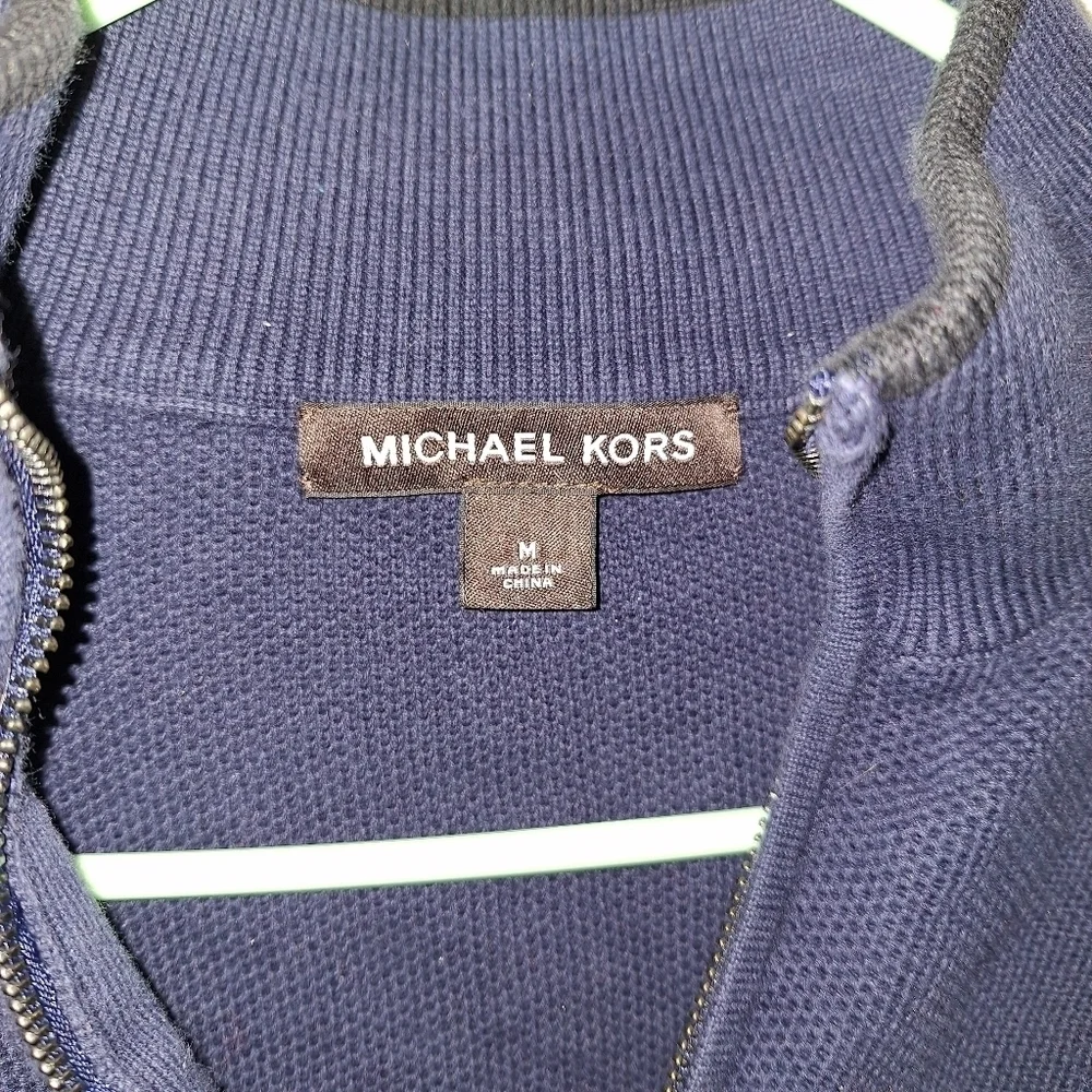 A Michael Kors men's 1/4 zip 100% cotton sweater in a size medium.